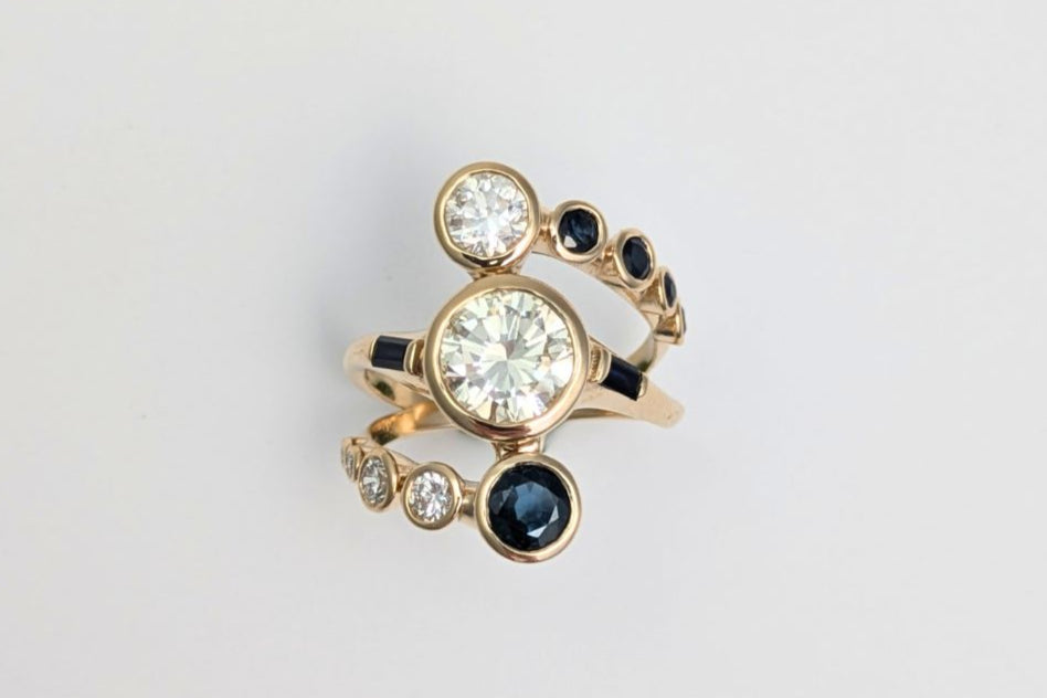 Gold ring with diamonds and sapphires in custom made setting.